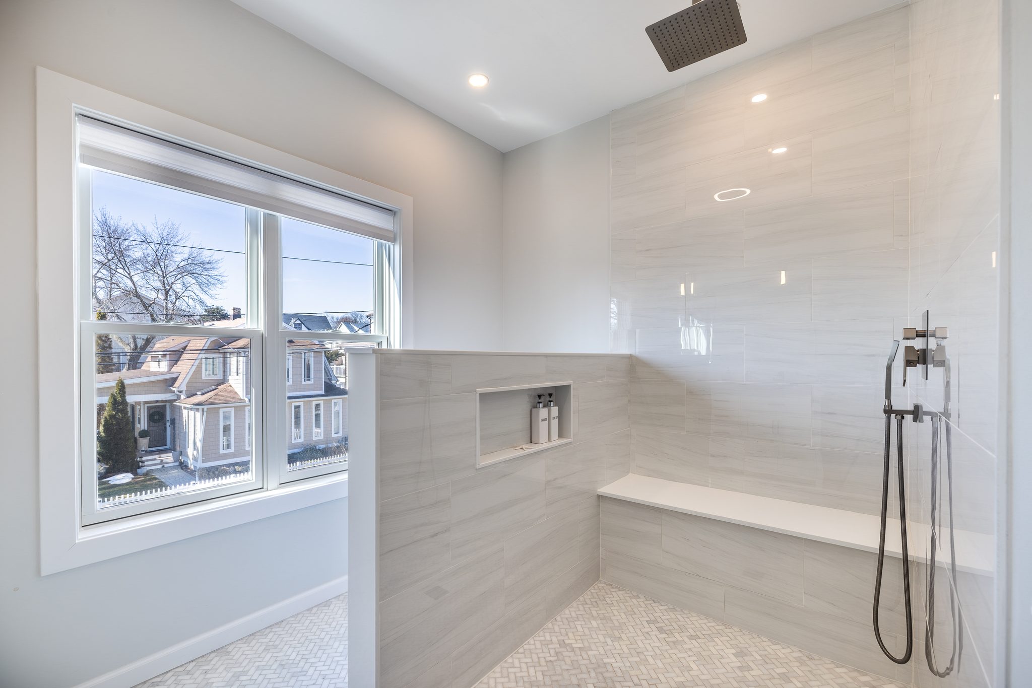 King suite bathroom with an oversized walk-in rain shower beside a window.