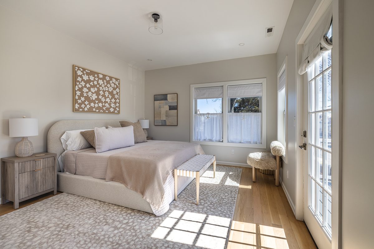 King suite bathed in luxurious linens and natural light.