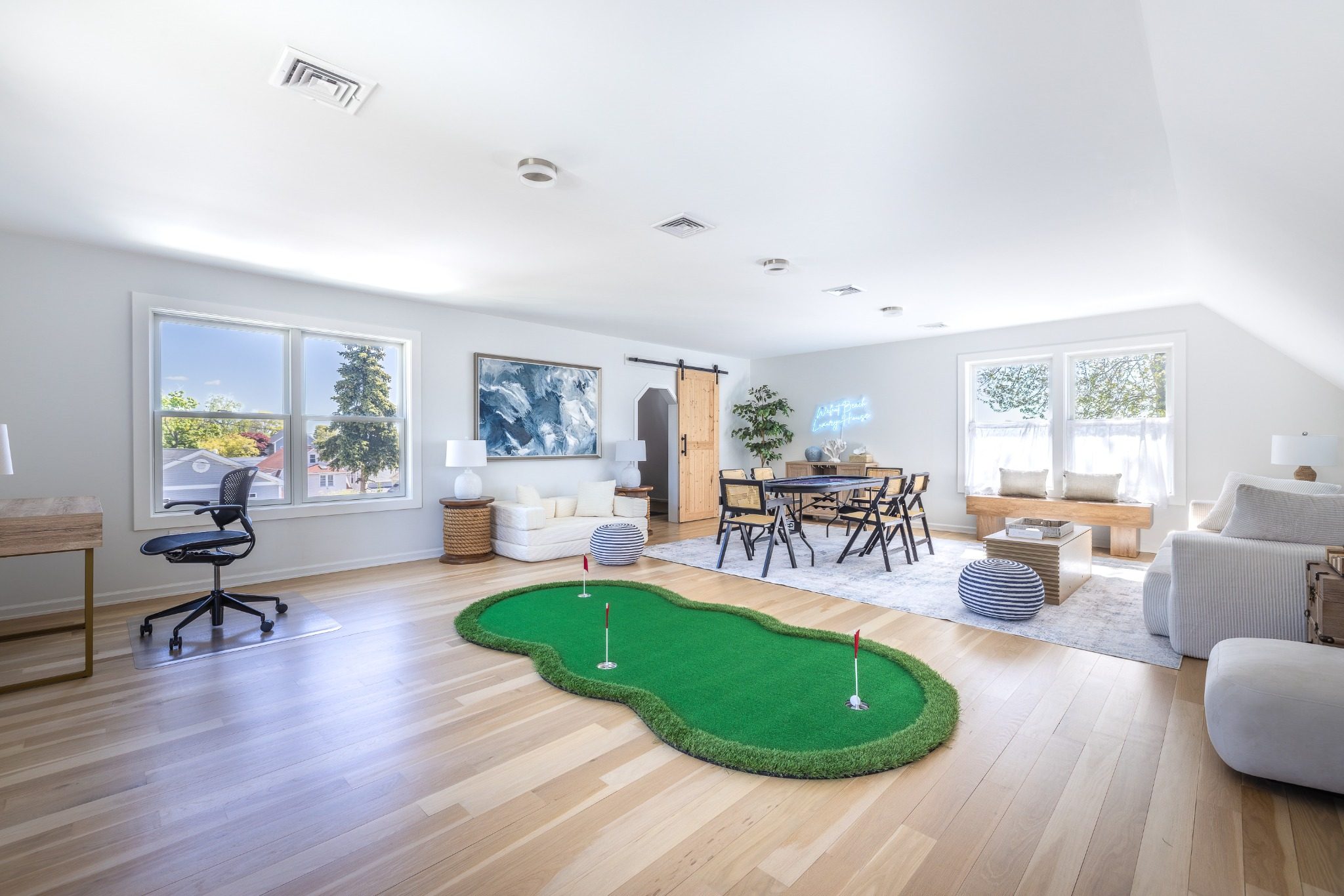 Third-floor rec room with poker table and games beneath the WBLH frame.