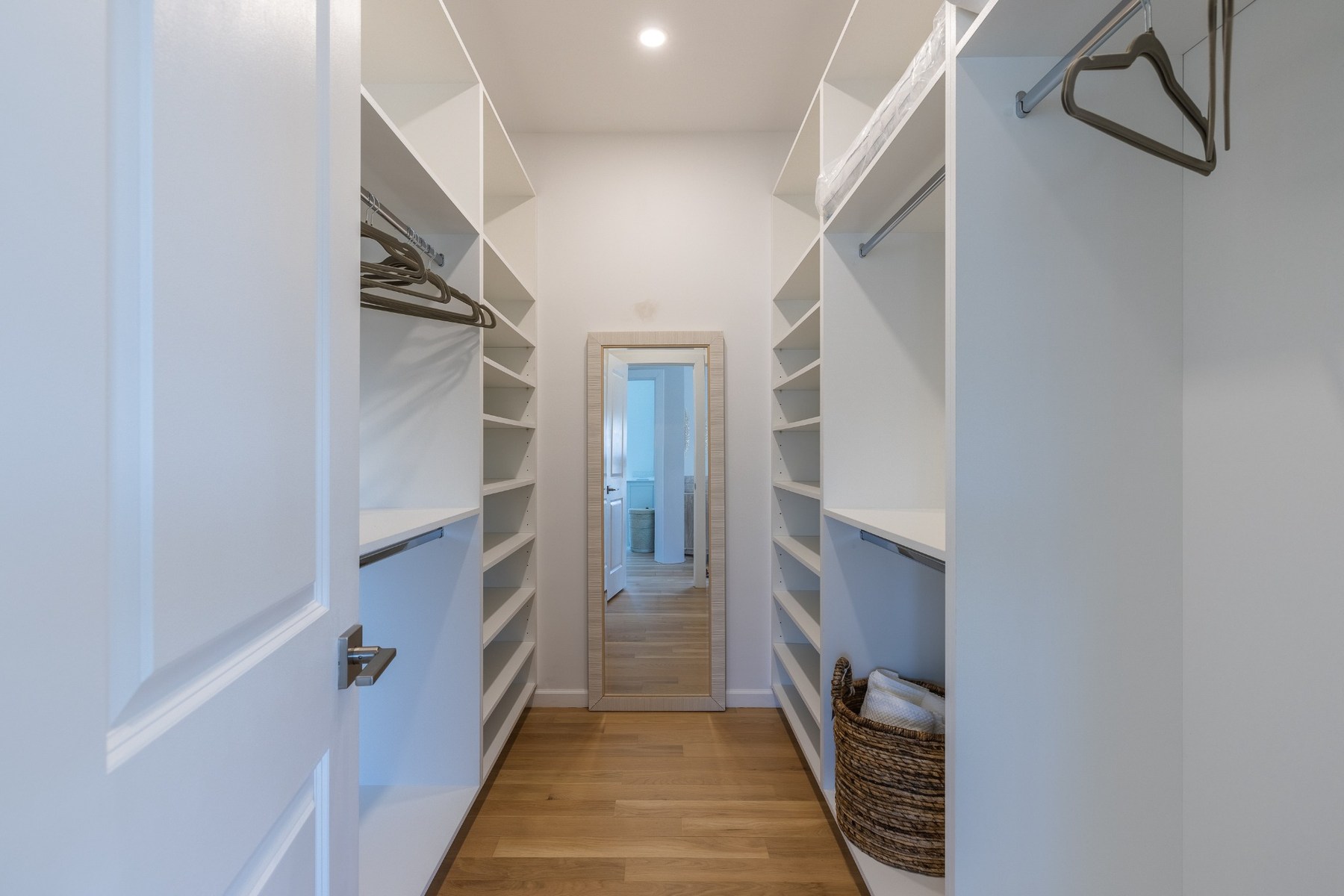 Oversized walk-in closet in the primary suite with built-in shelving and hanging space.